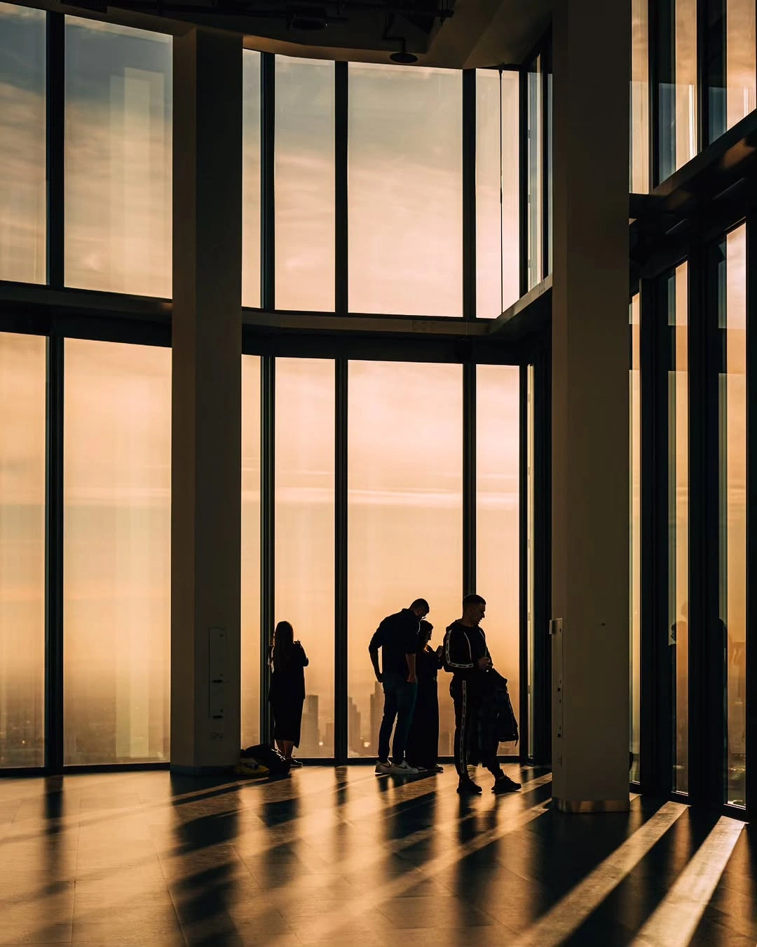 Silhouetted people in a sunlit office